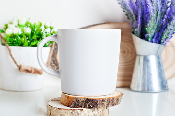 White mug on a background of flowers . Mock up. Template Space for creative artwork. Lettering text product promotion branding.