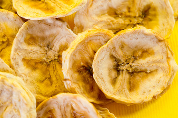 Dried banana chips, sliced in thin circles. Background for healthy and natural nutrition.