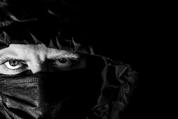 self-quarantine mask mode comcept - face in black surgical mask, also known as a procedure mask,...