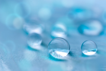 Beautiful transparent water drops or rain water on soft background. Macrophotography. Desktop background. Selective focus.