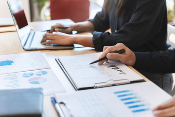 Business executives discussing a data documents in modern office.