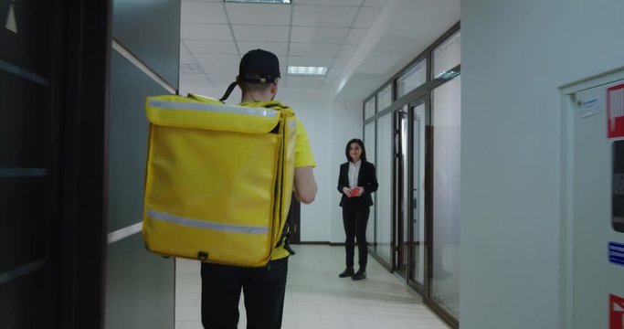 Food delivery boy running to businessman