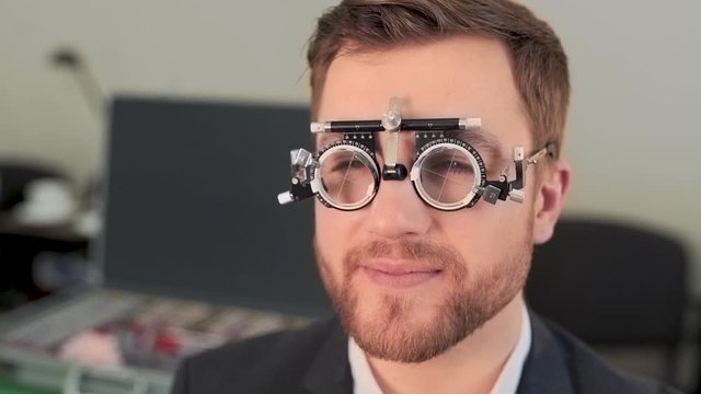 handsome man picks up lenses in ophthalmologist's office