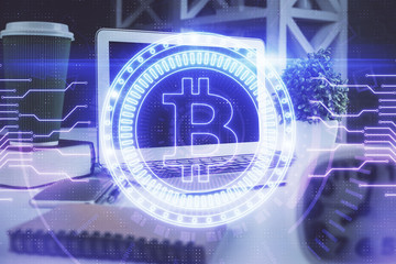Multi exposure of blockchain and crypto economy theme hologram and table with computer background. Concept of bitcoin cryptocurrency.