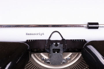 The word Manuscript typed on retro black typewriter