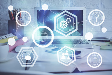 Computer on desktop with social network hologram. Multi exposure. Concept of international people connections.