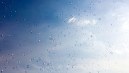 Soap bubbles fly in the blue sky