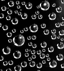 Air balls in water on a black background