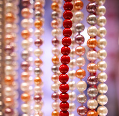 Pearl beads on a pink counter