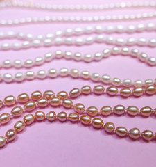 Pearl beads on a pink counter