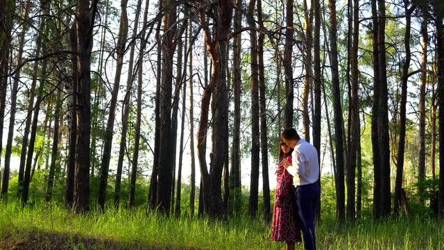 Loving couple in the forest on a sunny day. To love each other