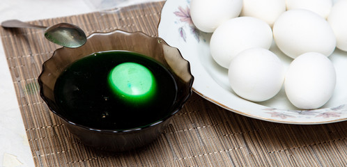 Painting eggs in the kitchen.