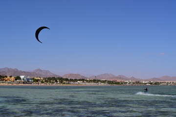 kitesurfing on the surface of the Red Sea with mountains