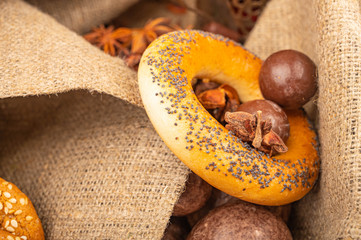 Chocolate, bagels and chocolate gingerbread on a background of coarse fabric. Close up.