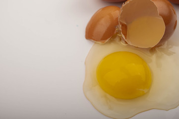 A broken chicken egg on a white background. Close up.