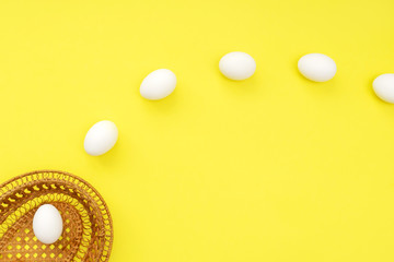 White eggs fly into pottle on yellow