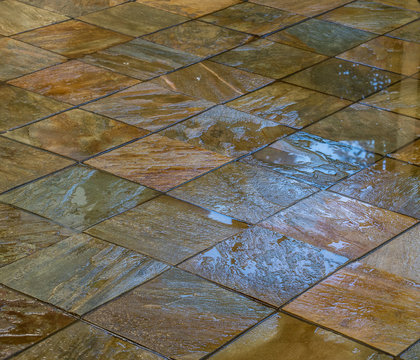 Wet stone earth colored tiles full frame image for background use with copy space