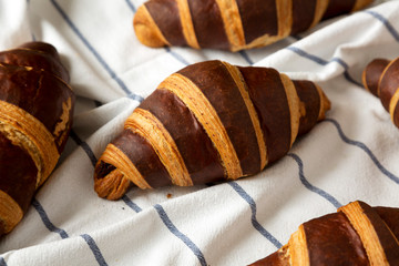 Homemade Croissants with Chocolate on cloth, low angle view. Close-up.