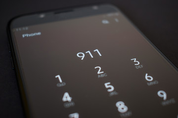 Close up smartphone calling 911 emergency services number