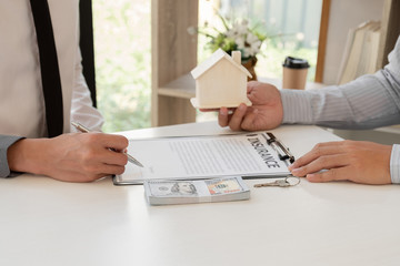 Real estate agent broker with home insurance forms In order for the customer to sign the contract according to the agreement buying home insurance officially Home insurance concept