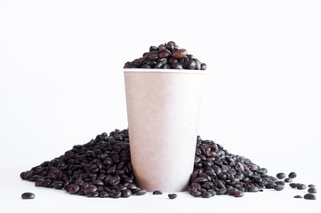 Whole bean coffee. Paper cup with coffee. On white background.