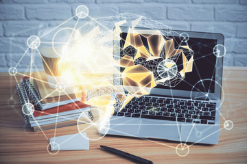 Double exposure of table with computer and brain hologram. Data innovation concept.