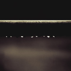 interesting abstract water drops on a black and white metal tube