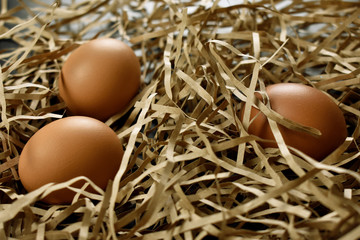 chicken eggs on a light straw background
