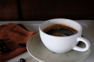 cup of coffee and beans on wooden table