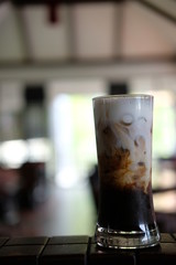 Iced coffee with milk on table