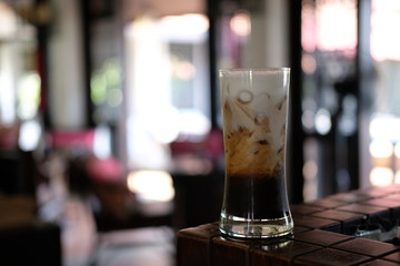Iced coffee with milk on table
