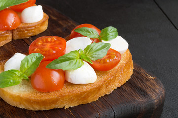 Caprese salad with ripe tomatoes and mozzarella with fresh Basil leaves. Italian food.