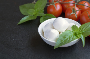 Caprese salad with ripe tomatoes and mozzarella with fresh Basil leaves. Italian food.