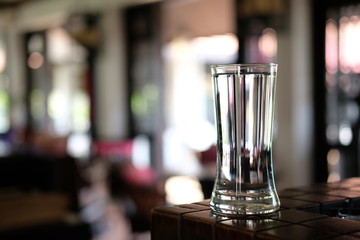 Glass of water on wood table background