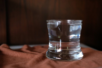 Glass of water on wood table background
