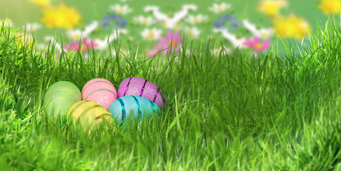 Beautiful decorative easter eggs lie in green grass