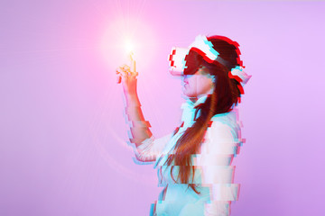 Woman is using virtual reality headset. Image with glitch effect.