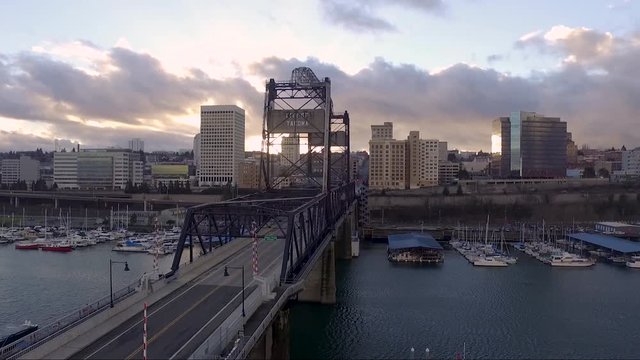 Aerial, rising, drone shot overlooking the 11th St Bridge, on the Thea Foss Waterway, at sunset, in Tacoma WA, USA