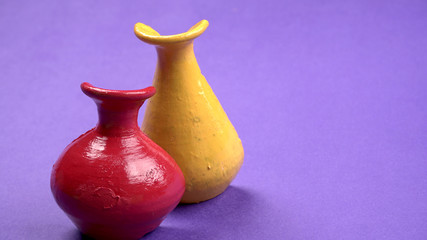 Beautiful empty decorative ceramic pots in warm happy colors on colorful background.