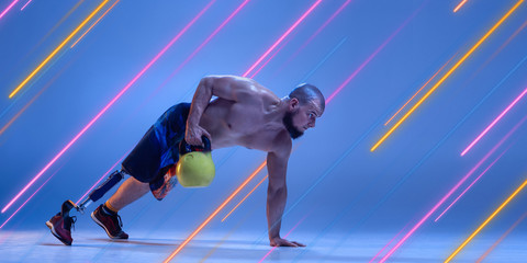 Fototapeta na wymiar Creative sport and neon lines on blue background, flyer, proposal. Male bodybuilder training in action and motion. Concept of hobby, healthy lifestyle, youth, action, movement, modern style. Inclusive