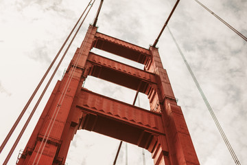 Close up shot of a red San Francisco Golden Gate Bridge and foggy sky.