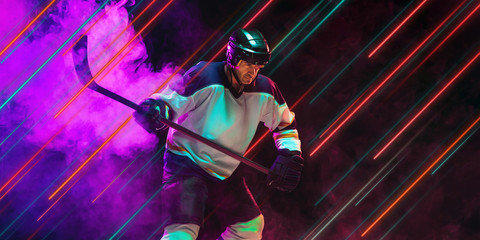 Fototapeta na wymiar Creative sport and neon lines on dark background, flyer, proposal. Male hockey player training in action and motion. Concept of hobby, healthy lifestyle, youth, action, movement, modern style.