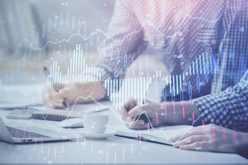 Multi exposure of forex chart with man working on computer on background. Concept of market analysis.