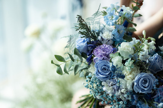 wedding bouquet of blue and purple flowers.