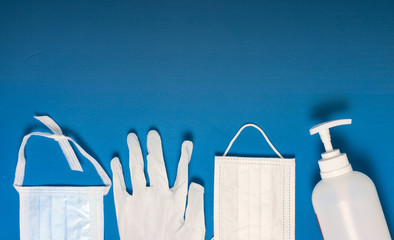 Medical mask, glove and disinfectant for corona virus on blue background
