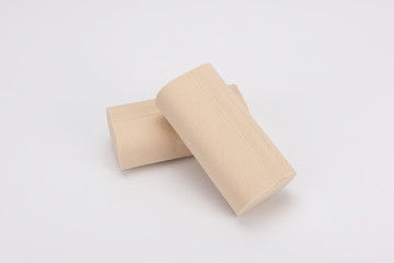 The toilet paper is made from raw grey wood pulp on a white background