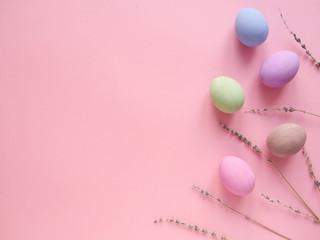 Flat lay composition of Happy Easter holiday concept. Colorful pastel egg with lavander flower on pink background. Copyspace, top view.