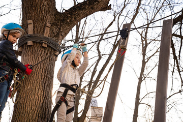 child girl study climb in rope Park in spring