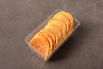 Homemade potato chips in a vintage ground background