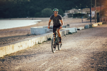 Man ride mountain bike on the beach. Sport and active life concept.